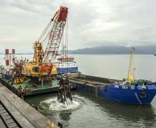 Os berços do Porto de Paranaguá começam a ser dragados por um draga mecânica, nesta sexta-feira (6). Esta é a primeira vez que uma “Clamshell” realiza obras nos portos paranaenses. A diferença entre essa e as embarcações comuns na realização desse serviço marítimo, no Estado, é a precisão e a segurança para dragar mais próximo ao costado.